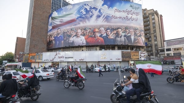 A huge billboard featuring a symbolic image of Iranian people, military commanders, and nuclear scientists killed in Israeli attacks is seen in Tehran